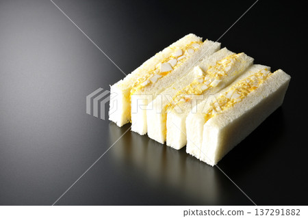 Egg sandwich photographed against a black background Egg sandwich photographed against a black background 137291882