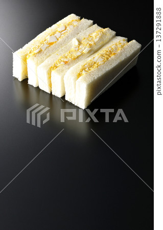 Egg sandwich photographed against a black background Egg sandwich photographed against a black background 137291888