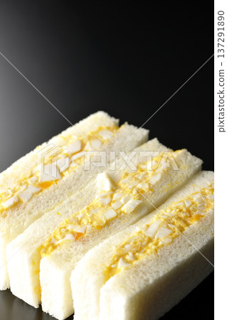 Egg sandwich photographed against a black background Egg sandwich photographed against a black background 137291890