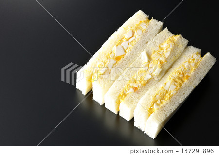 Egg sandwich photographed against a black background Egg sandwich photographed against a black background 137291896