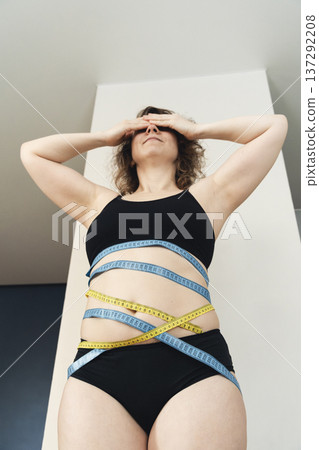 Woman stressing about body image and weight loss Woman stressing about body image and weight loss 137292208