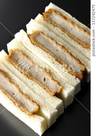 Photographing pork fillet cutlet sandwich against a black background Photographing pork fillet cutlet sandwich against a black background 137292475