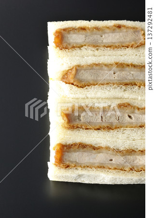 Photographing pork fillet cutlet sandwich against a black background 137292481