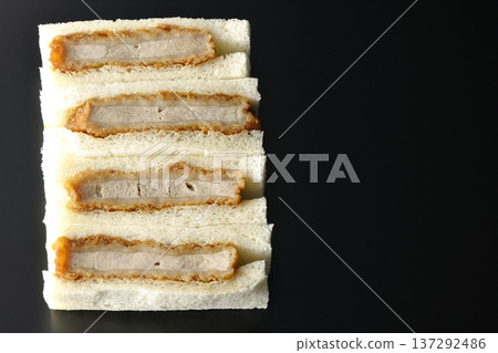 Photographing pork fillet cutlet sandwich against a black background Photographing pork fillet cutlet sandwich against a black background 137292486