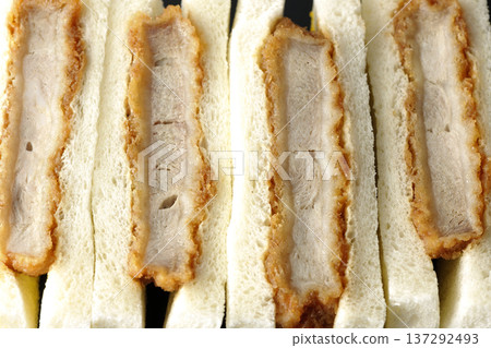Photographing pork fillet cutlet sandwich against a black background Photographing pork fillet cutlet sandwich against a black background 137292493