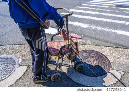 Yokohama cityscape in Japan, an aging society... An elderly man (wearing a mask) in a silver cart... = Yokohama city 137293041