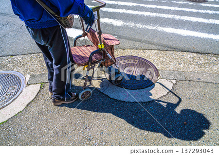 Yokohama cityscape in Japan, an aging society... An elderly man (wearing a mask) in a silver cart... = Yokohama city 137293043