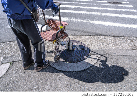 Yokohama cityscape in Japan, an aging society... An elderly man (wearing a mask) in a silver cart... = Yokohama city Yokohama cityscape in Japan, an aging society... An elderly man (wearing a mask) in a silver cart... = Yokohama city 137293102