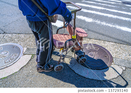 Yokohama cityscape in Japan, an aging society... An elderly man (wearing a mask) in a silver cart... = Yokohama city 137293140