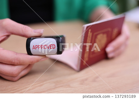 Passport checks bring joy as approval stamp seals the travel dream during a sunny afternoon in a cozy office Passport checks bring joy as approval stamp seals the travel dream during a sunny afternoon in a cozy office 137293189
