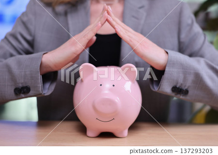 Protecting savings with care during important financial planning moments in a modern office setting Protecting savings with care during important financial planning moments in a modern office setting 137293203