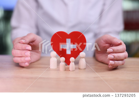 Caring hands protect a heart symbol representing health and family, showcasing the bond of togetherness and wellness Caring hands protect a heart symbol representing health and family, showcasing the bond of togetherness and wellness 137293205