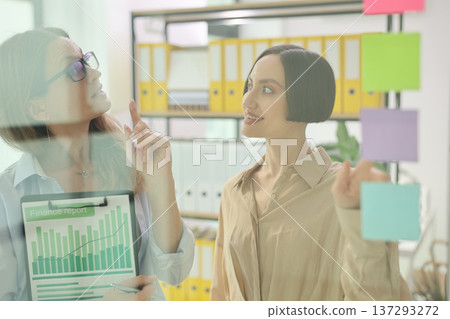 Creative brainstorming during a vibrant work session in a modern office setting, highlighting teamwork and dynamic ideas 137293272