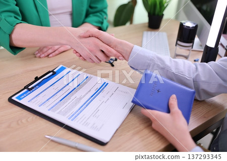 Successful handshake seals the deal during a business meeting in a modern office setting 137293345