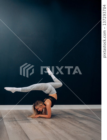 Young Woman Stretches Her Body While Practicing Yoga In Activewear At Home For Fitness. Girl Stretching, Enjoying Fitness Training Yoga And Healthy Lifestyle. Young Woman Stretches Her Body While Practicing Yoga In Activewear At Home For Fitness. Girl Stretching, Enjoying Fitness Training Yoga And Healthy Lifestyle. 137293784