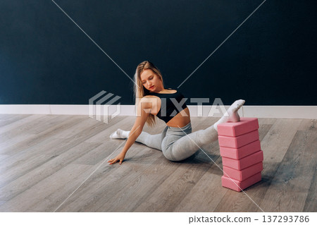 Portrait Of Beautiful Young Female Doing Stretching, Girl Exercising and Enjoying Fitness Training And Healthy Lifestyle. Yoga for healt. 137293786