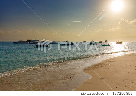 Sunset glows over calm turquoise waters 137293895