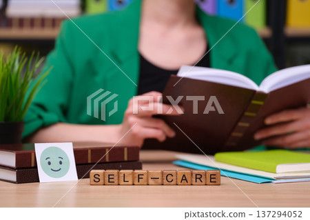 Engaging in self-care through reading and reflection in a cozy study space filled with vibrant books and greenery 137294052