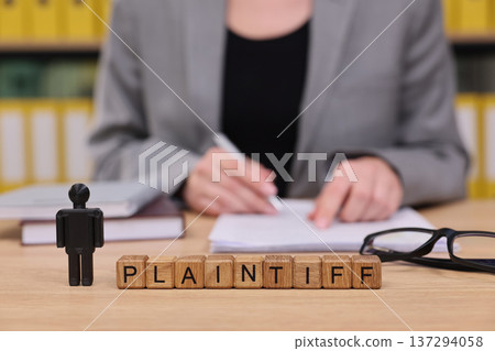 Courtroom scene captures a plaintiff preparing for a legal case with determination and focus in a professional office environment Courtroom scene captures a plaintiff preparing for a legal case with determination and focus in a professional office environment 137294058