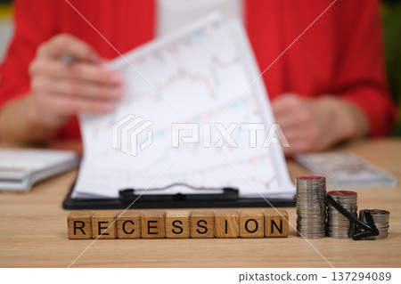 Understanding economic downturns through recession signs, charts, and careful financial analysis in a modern office setting Understanding economic downturns through recession signs, charts, and careful financial analysis in a modern office setting 137294089