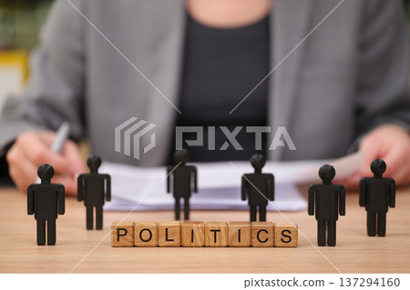 Engaging in political discussions with wooden figures representing diverse viewpoints in a formal setting 137294160