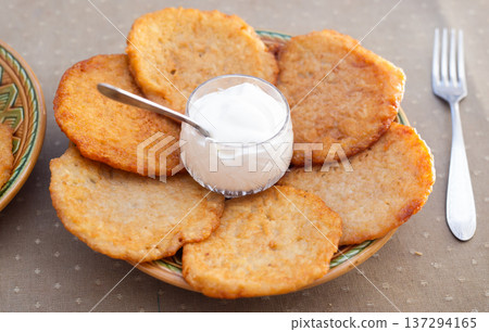 Crispy Potato Pancakes with Cream Topping 137294165