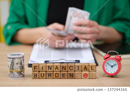 Financial struggles represented through cash, time, and words in a personal finance setting filled with tension 137294168