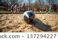 A rocket in the sand on a playground in a park during daylight. Conceptualizing the consequences of war, security issues and violations of the peace, and child safety. 137294227
