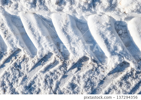 Compressed Snow Pattern With Heavy Vehicle Tire Imprints In Winter Compressed Snow Pattern With Heavy Vehicle Tire Imprints In Winter 137294356