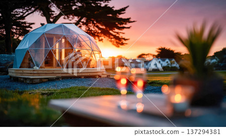 Luxury geodesic dome glamping cabin at sunset with warm golden light, modern eco retreat in nature Luxury geodesic dome glamping cabin at sunset with warm golden light, modern eco retreat in nature 137294381