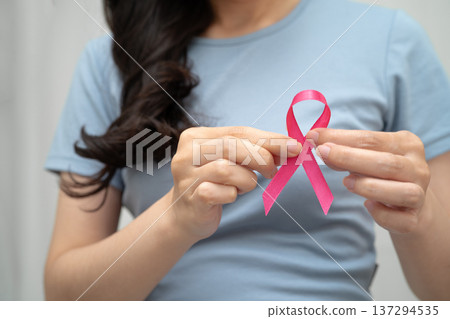 Asian woman with pink ribbon, World Breast Cancer Day at October. 137294535