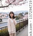 Cherry blossoms and a woman wearing a cardigan 137294719