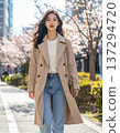 A Japanese woman walking through the streets in spring 137294720