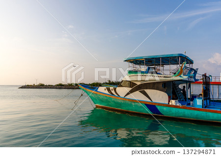 Colorful boat floats calm turquoise waters Colorful boat floats calm turquoise waters 137294871