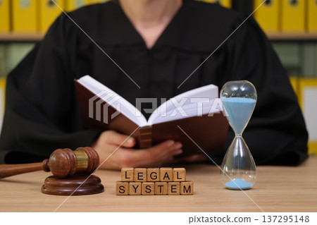 Legal principles come to life as a judge reviews case files, emphasizing the importance of time within the judicial process 137295148