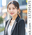 A woman wearing a suit in a business district 137295475