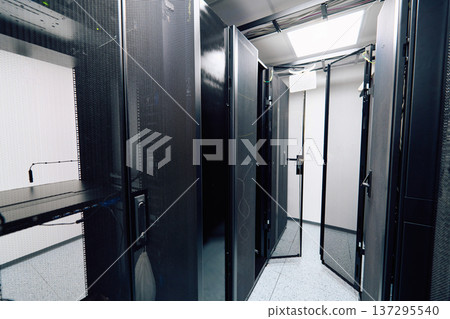 Empty server room aisle with open racks and network equipment in a modern data center Empty server room aisle with open racks and network equipment in a modern data center 137295540