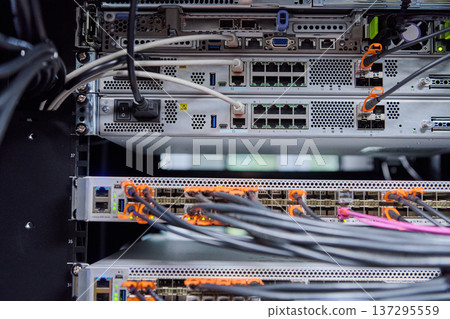Network server rack with fiber optic cables and switches in a modern data center Network server rack with fiber optic cables and switches in a modern data center 137295559