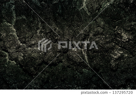 A solid monotone texture with a faint light source shining on the dark, rough rock surface of nervous despair 137295720