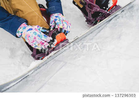 A woman wearing a snowboard A woman wearing a snowboard 137296303