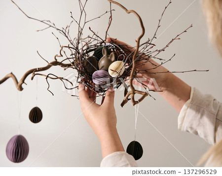 Colorful Paper Eggs and Chocolate Rabbit in Nest 137296529
