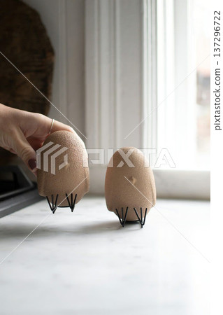 Woman Hand Holding Decorative Chicken in Eggshell Woman Hand Holding Decorative Chicken in Eggshell 137296722