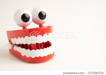 Funny red teeth with eye toy denture model for dental health care. 137296734