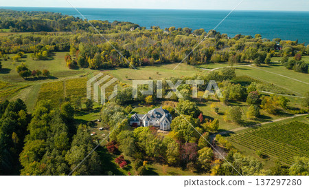 Aerial panoramic view of countryside estate with mansion, vineyard fields and lake shoreline in autumn New York State USA Aerial panoramic view of countryside estate with mansion, vineyard fields and lake shoreline in autumn New York State USA 137297280