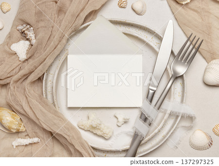 Mockup of envelope on plate with seashells, coral and beige fabric on stone, coastal wedding stationery Mockup of envelope on plate with seashells, coral and beige fabric on stone, coastal wedding stationery 137297325