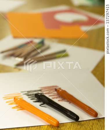 Foreground showing three colorful markers lying on a white paper with color swatches Foreground showing three colorful markers lying on a white paper with color swatches 137297415