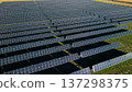 Aerial drone close view of solar power plant with long rows of photovoltaic panels generating renewable energy 137298375