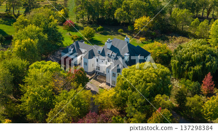 Aerial view of luxury countryside mansion surrounded by autumn trees and rural landscape in New York State USA 137298384