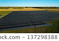 Aerial drone view of large solar power plant with rows of photovoltaic panels in rural landscape 137298388