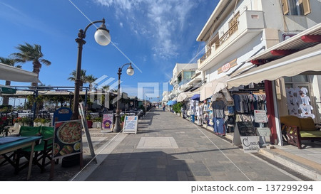 Main tourist street with restaurants and souvenir shops on both sides under the blue sky Main tourist street with restaurants and souvenir shops on both sides under the blue sky 137299294